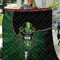 Green and black quilt with zipper trim and leprechaun artwork, held close-up