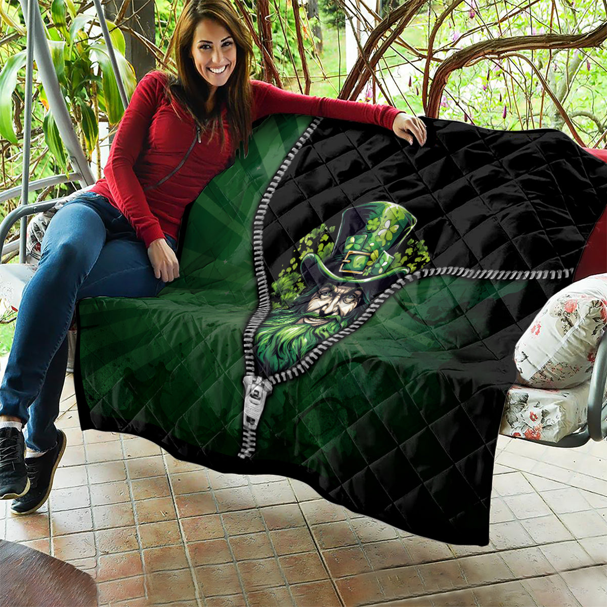 Green and black quilt with zipper edge and leprechaun graphic draped over sofa