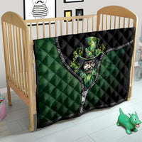Green and black quilt with zipper trim and leprechaun face graphic on wooden crib