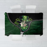 Green and black 3D zip-art tablecloth with multicolor graphic and zipper-style trim.