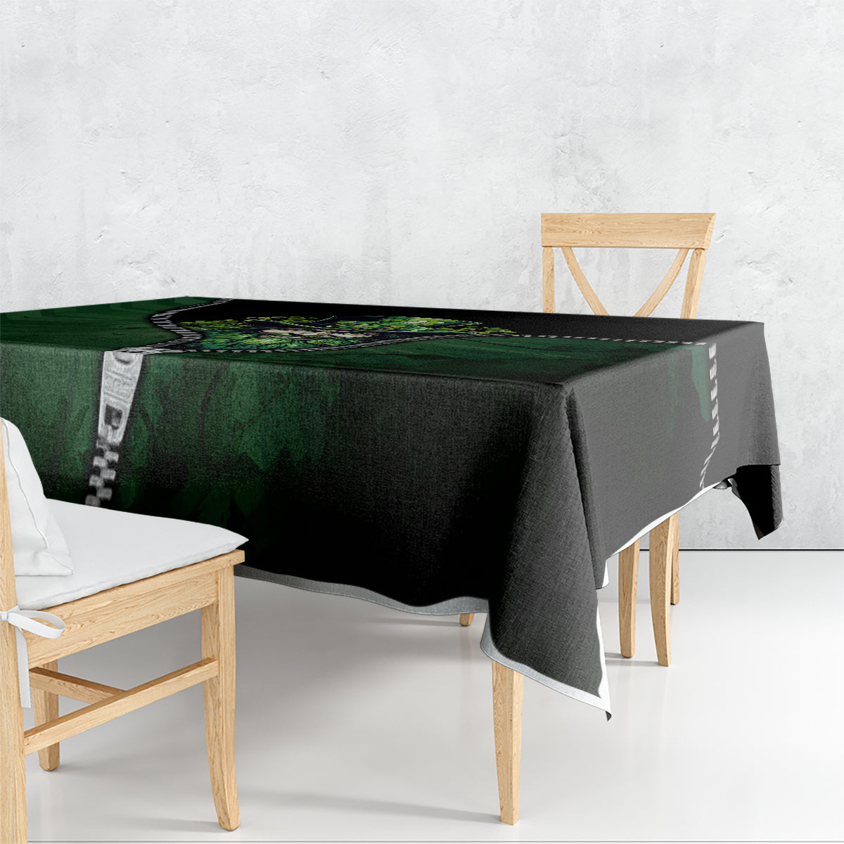 Green and black 3D zip-art tablecloth draped over a rectangular dining table, zipper trim.