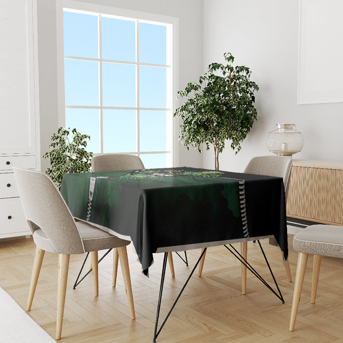 Green and black 3D zip-art tablecloth covering a dining table, zipper trim along the edge.