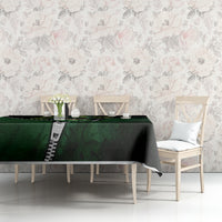 Green and black 3D zip-art tablecloth on a table, featuring a multicolor zipper-style graphic.