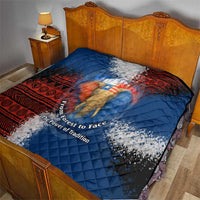 Blue quilt with red patterned edge and elephant image, diamond-quilted fabric on bed