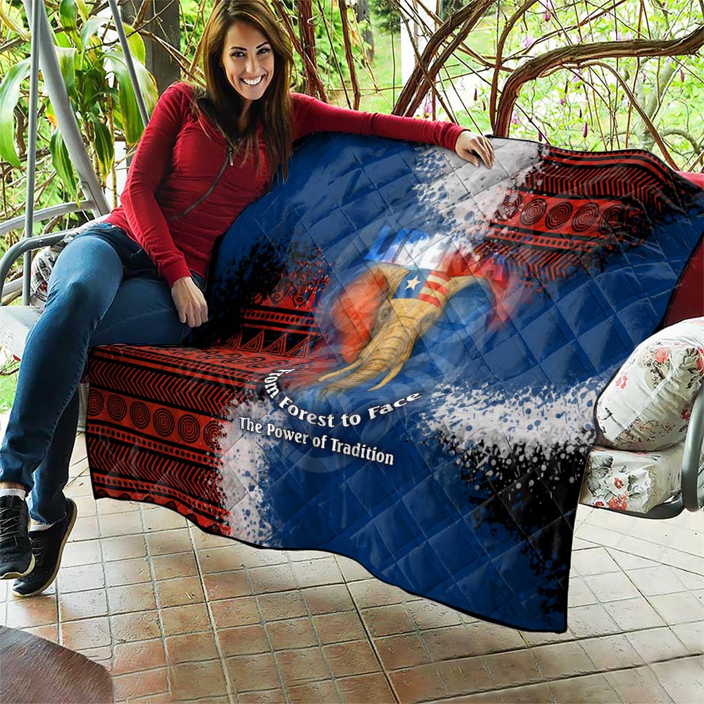 Blue quilt with red tribal design and elephant graphic, laid out on patio seating