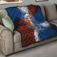 Blue quilt with red patterned border and elephant artwork, draped over beige sofa