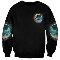Unisex black crewneck sweatshirt with small crescent moon skull graphic on chest