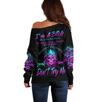 Black off-shoulder sweater with colorful lion graphic and 'Don't Try Me' back text