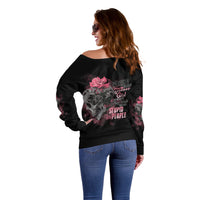 Black off-shoulder sweater back with warning-style text and skull rose graphic