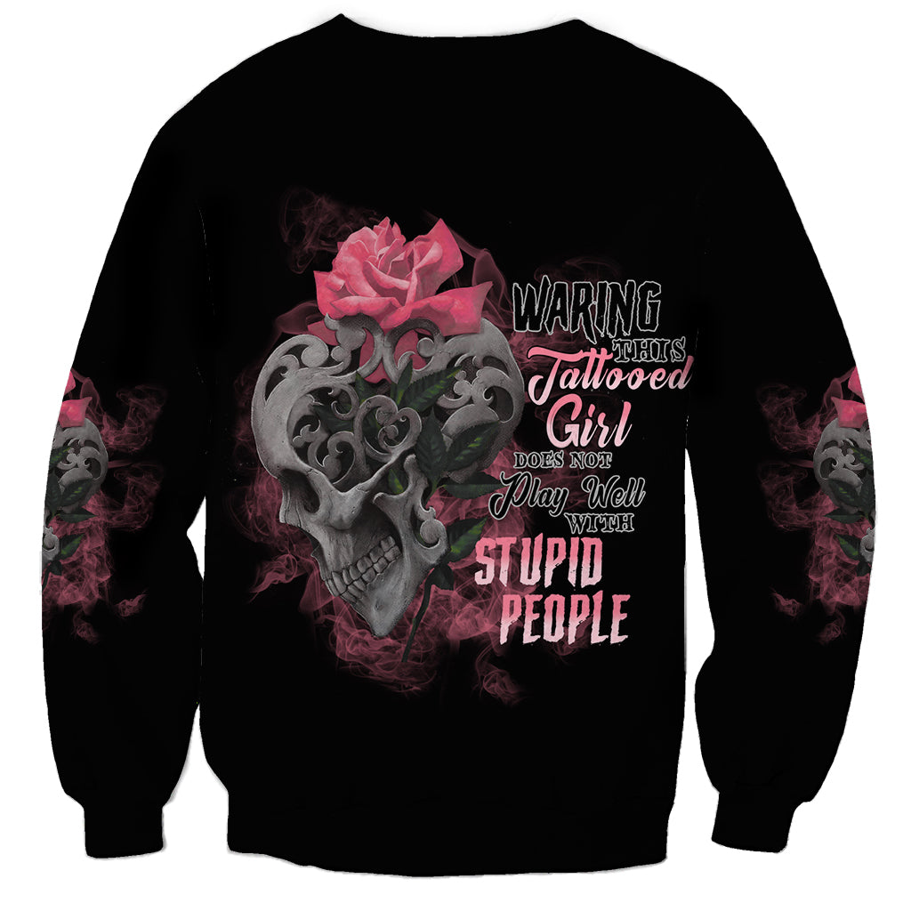 Unisex black sweatshirt with skull, pink rose graphic and multicolor text on front