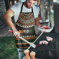 Apron with dark geometric bands and 'IVORY COAST' motto, black neck strap