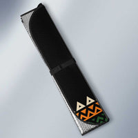 Folded auto sun shade, black fabric with multicolor geometric trim and strap