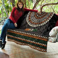 Black quilt with large geometric arc print, multicolor stripes, and “Ivory Coast” text