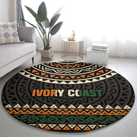 Round area rug with tribal stripes and “IVORY COAST” motto text across the center