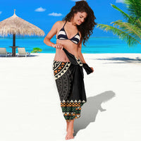 Black sarong tied at waist, tribal geometric border and 'IVORY COAST' print