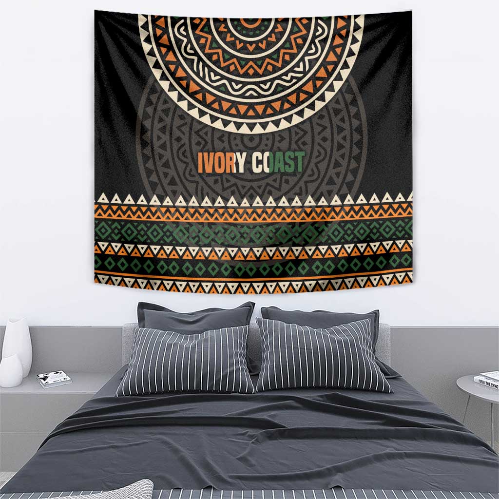 Ivory Coast tapestry, black base with ethnic geometric motifs, orange “IVORY COAST” lettering