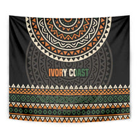 Ivory Coast tapestry close-up: black geometric mandala, orange “IVORY COAST” and striped band