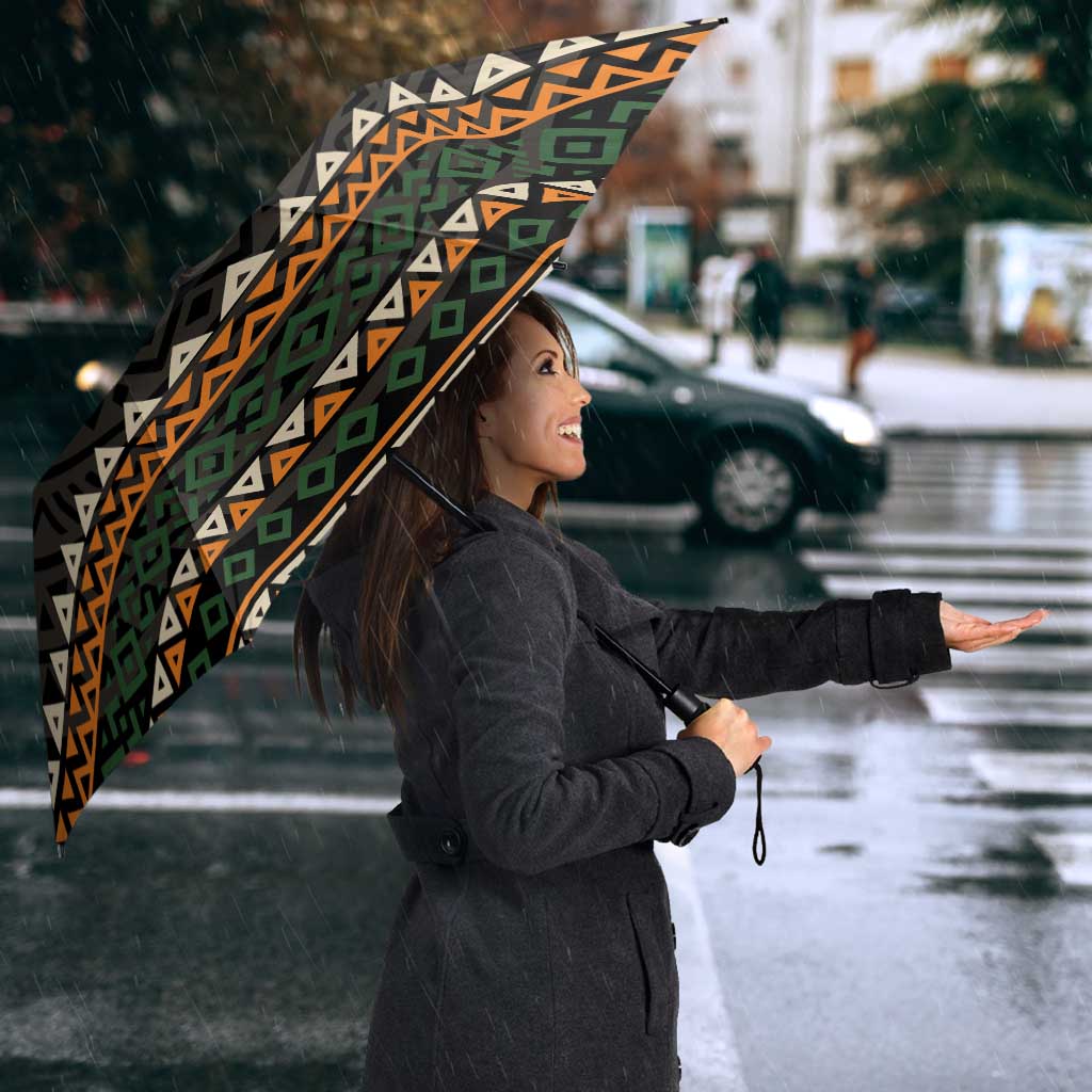 Open umbrella with multicolor ethnic geometric design and 'IVORY COAST' logo text