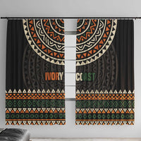 Black window curtain with multicolor geometric pattern and 'IVORY COAST' lettering