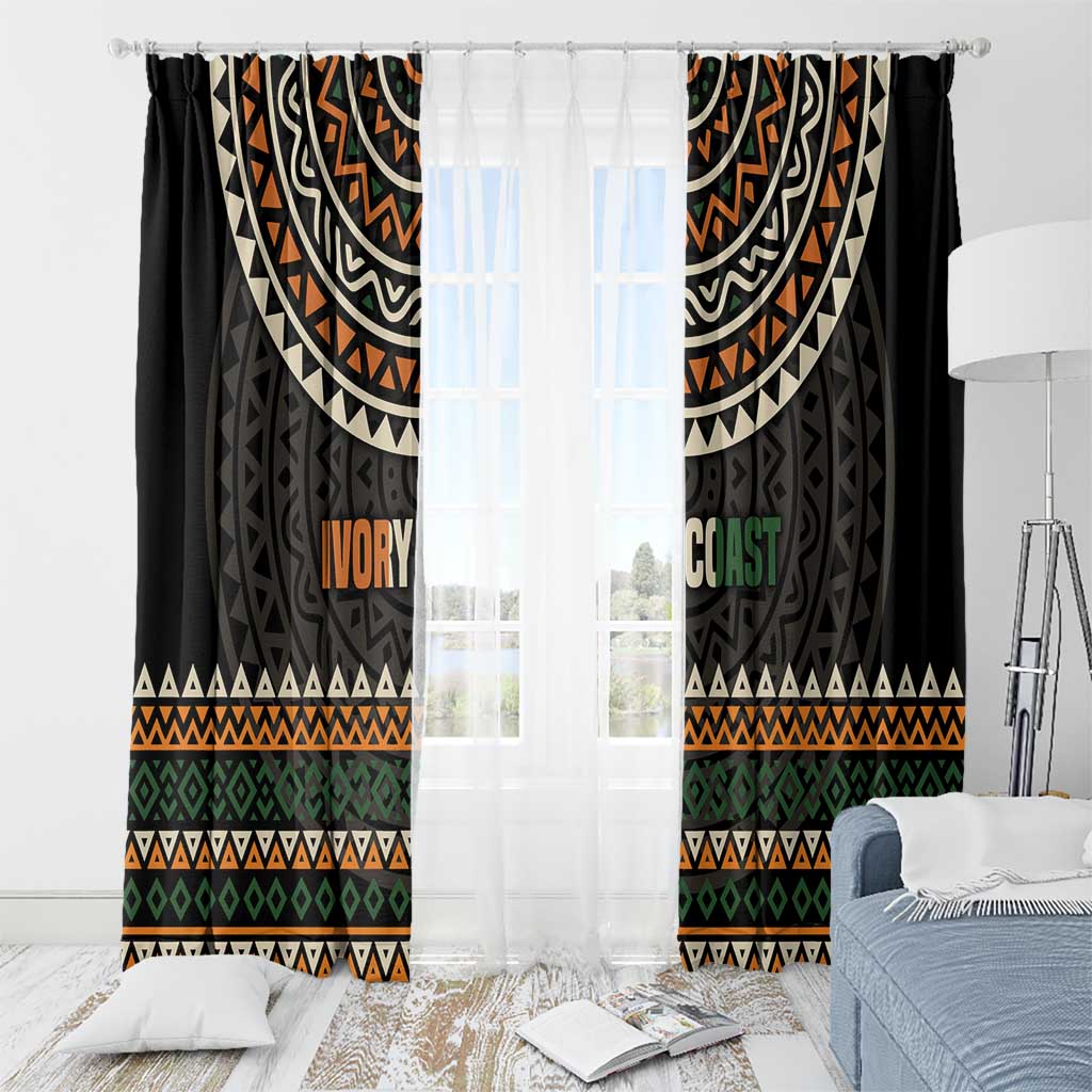 Black window curtains with multicolor geometric pattern and 'IVORY COAST' text panel