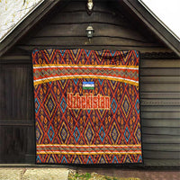 Multicolor Uzbekistan quilt hanging on wooden wall with diamond pattern and orange stripe