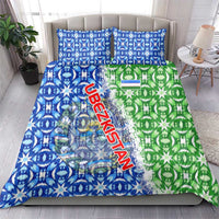 Blue and green ikat-style duvet with Uzbekistan text and emblem, matching pillow covers on bed
