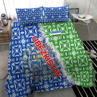 Close view of blue and green patterned duvet with Uzbekistan lettering and coat emblem, twin pillows