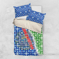 Folded blue and green duvet with Uzbekistan text and emblem, plus two blue pillow covers