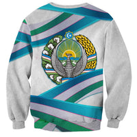 Unisex light gray sweatshirt with back crest emblem on teal, purple, and green stripes