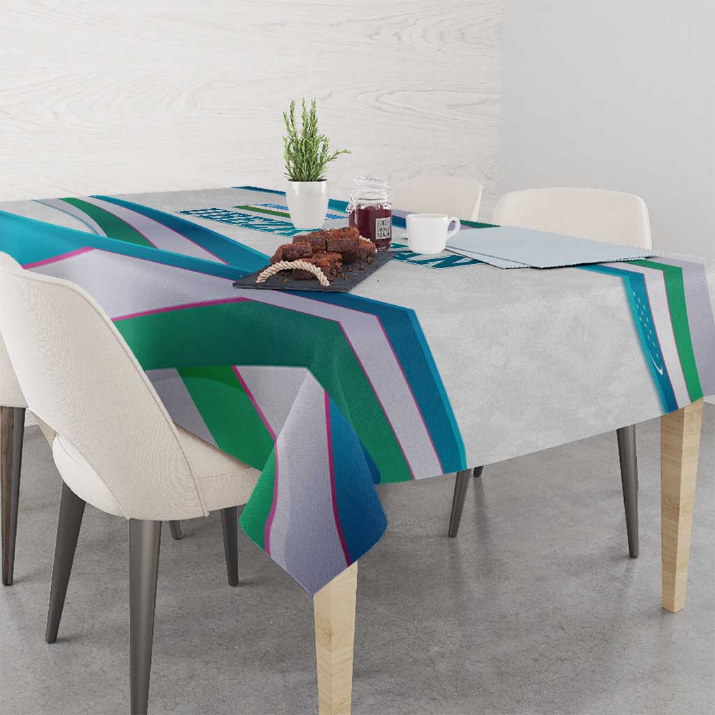 Multicolor ribbon-wave tablecloth on dining table with overhanging corners.