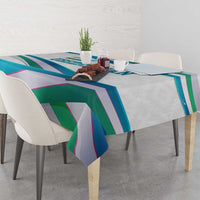 Multicolor ribbon-wave tablecloth on dining table with overhanging corners.