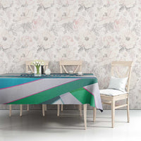 Multicolor ribbon-wave tablecloth on dining table with teal, green, and purple stripes.