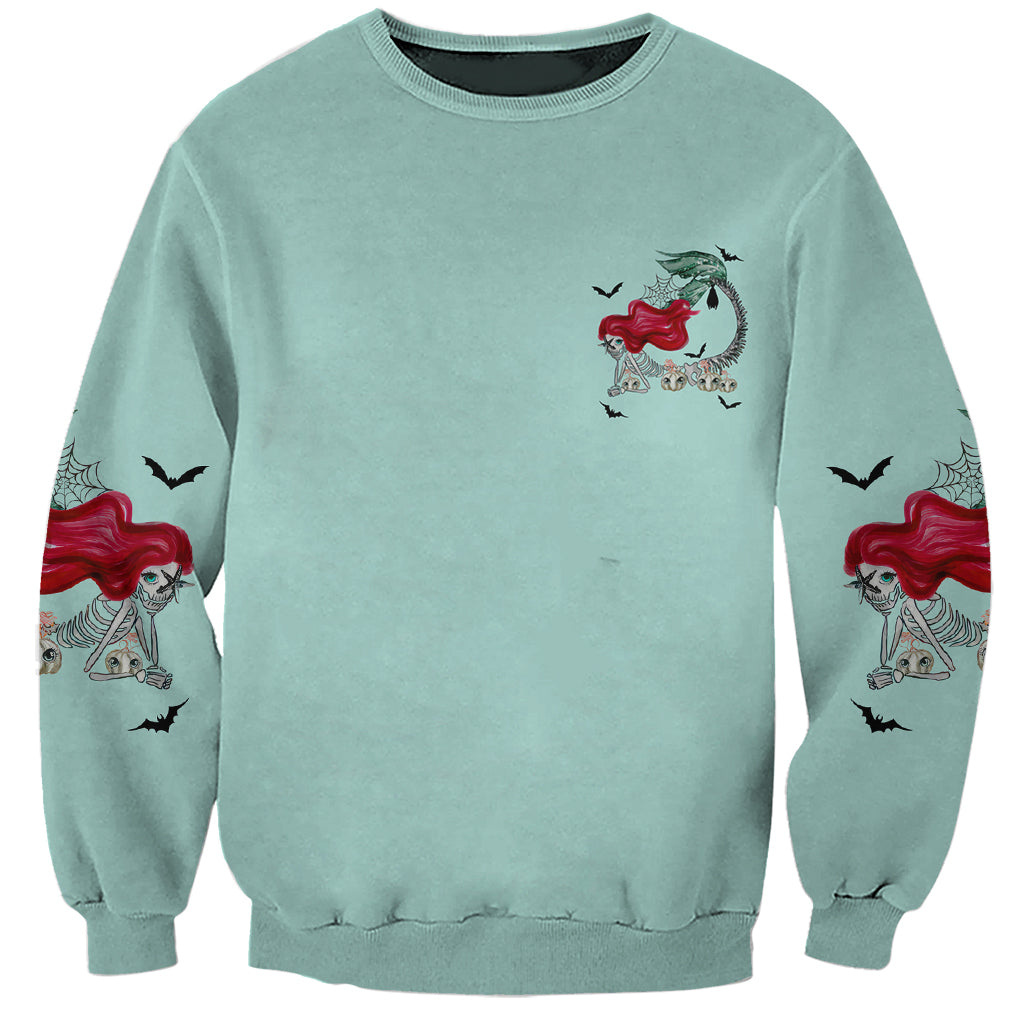 Aqua Halloween sweatshirt with small mermaid witch chest graphic and sleeve prints