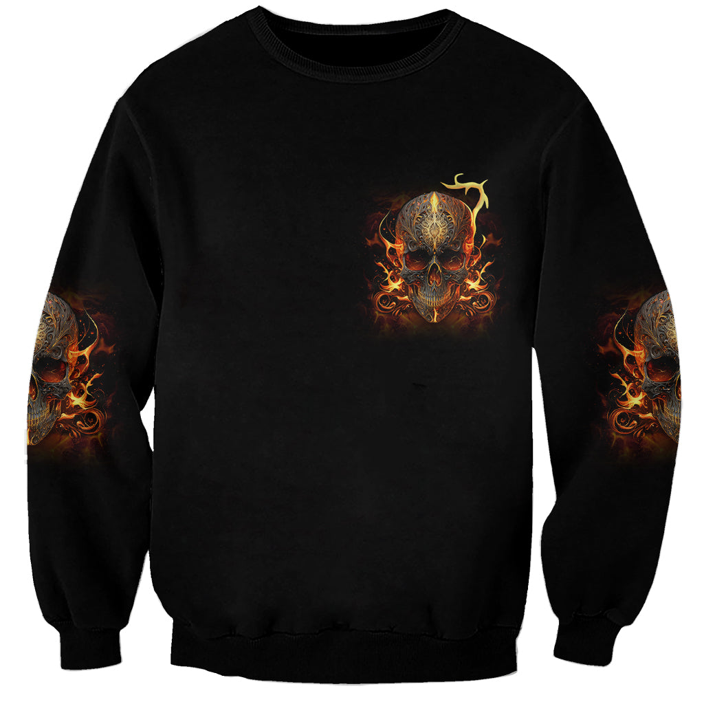 Black crewneck sweatshirt with small flaming skull chest print and orange sleeve art