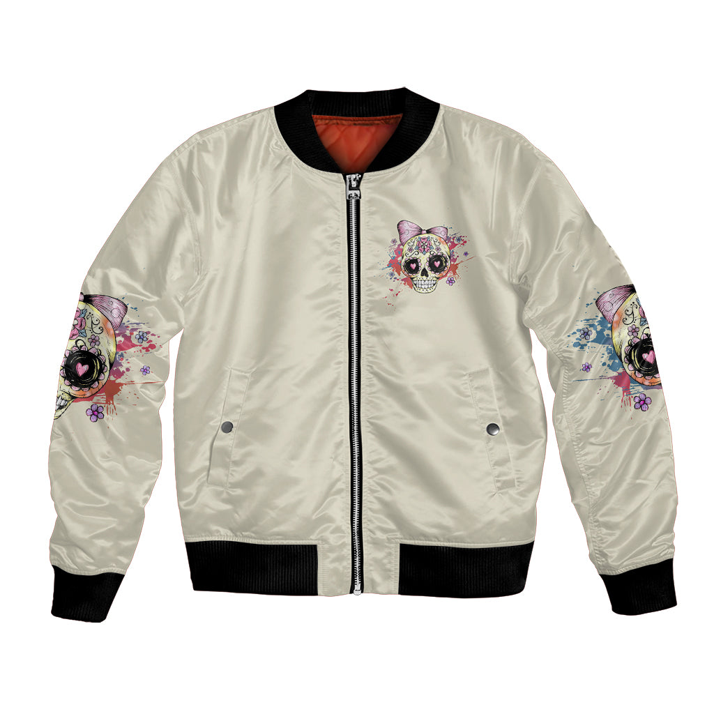 Cream bomber jacket with front zipper and small skull-girl patch, ribbed cuffs