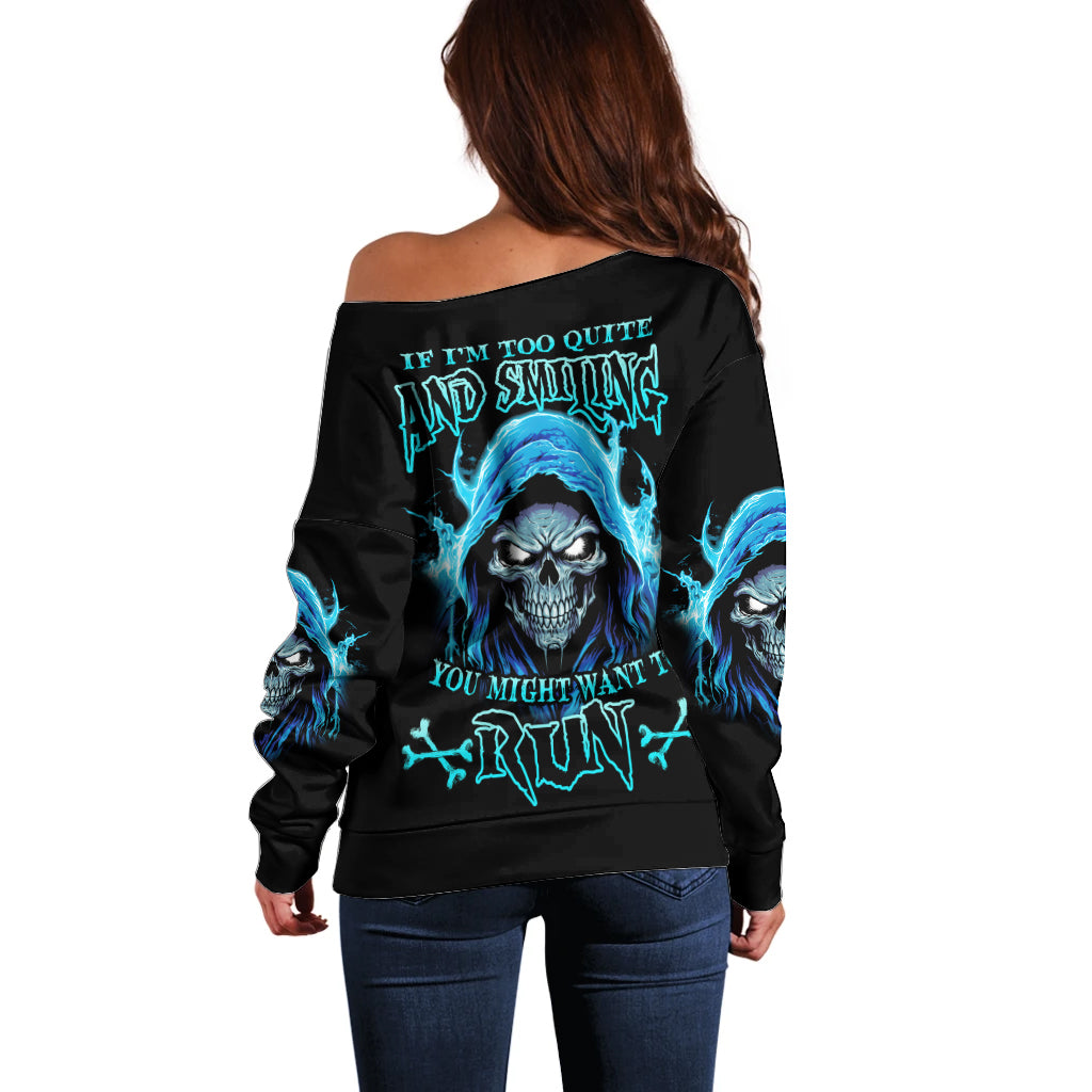 Black off-shoulder sweater with blue skull graphic on back and long sleeves