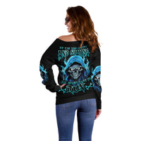 Black off-shoulder sweater with large blue skull graphic and text on back