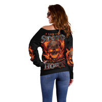 Black off-shoulder sweater with flame skull graphic and slogan on back