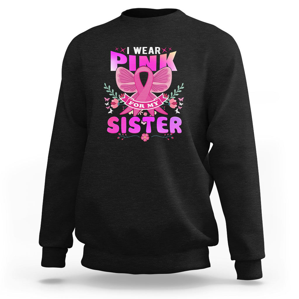 Black sweatshirt with pink breast awareness graphic reading “I wear pink for my sister”