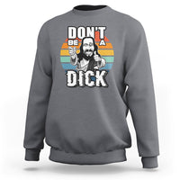 Charcoal gray crewneck sweatshirt with colorful “Don’t be a Dick” Jesus graphic on front