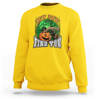 Yellow Halloween sweatshirt with front graphic of a jack-o’-lantern and text “FIND YOU”.