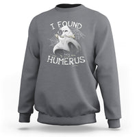 Light gray sweatshirt with front “I FOUND THIS HUMERUS” skeleton and spiderweb graphic