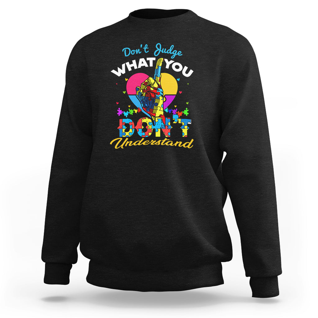 Black autism awareness sweatshirt with colorful "Don't Judge What You Understand" graphic