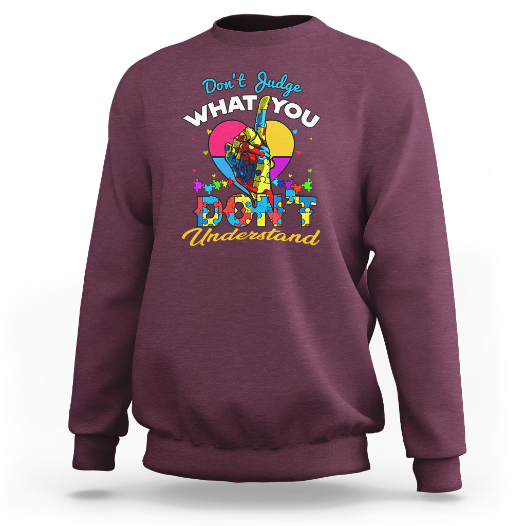Maroon autism awareness sweatshirt with colorful "Don't Judge What You Understand" graphic