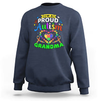 Navy crewneck sweatshirt with long sleeves and “Proud Autism Grandma” graphic