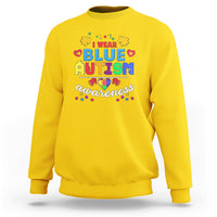 Daisy yellow crewneck sweatshirt with colorful “Blue Autism Awareness” graphic on chest