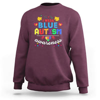 Maroon crewneck sweatshirt with colorful “Blue Autism Awareness” graphic on chest
