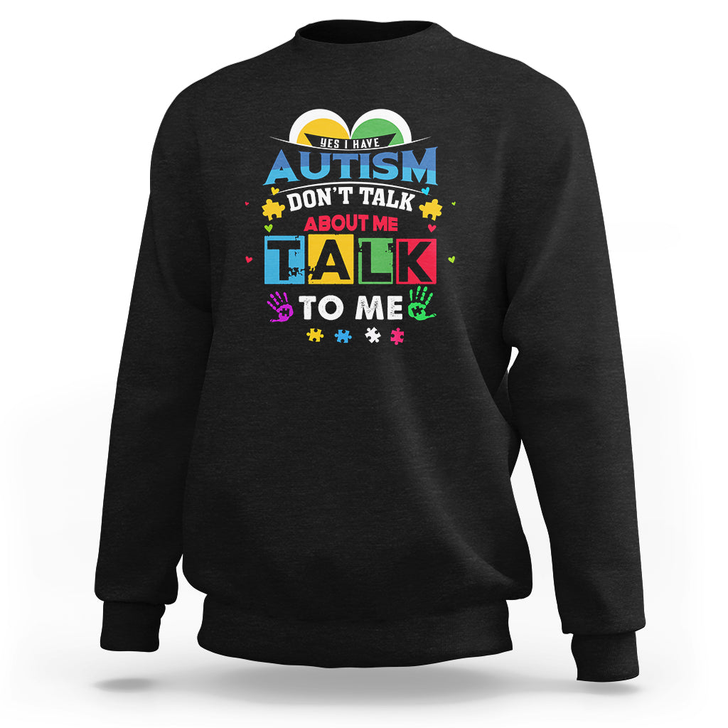 Black sweatshirt with colorful Autism slogan: "Don't Talk About Me, Talk To Me".
