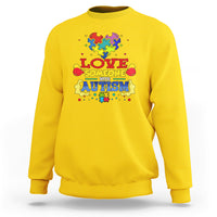 Yellow sweatshirt with colorful puzzle heart autism slogan graphic