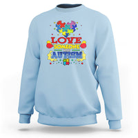 Light blue sweatshirt with colorful puzzle heart autism slogan graphic